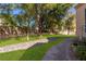 Beautiful manicured lawn with mature trees, rock accents, and a walkway; lovely landscaping creates a peaceful outdoor space at 229 Drysdale Cir, Henderson, NV 89074