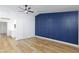 Bedroom featuring a navy accent wall and adjacent ensuite bathroom at 2405 Pickwick Dr # 55, Henderson, NV 89014