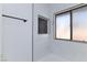 Bathroom with white tile, black fixtures, accent tile, and a window at 2405 Pickwick Dr, Henderson, NV 89014