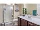 Cozy bathroom featuring a glass shower, white cabinets, a vanity, and a decorative Eiffel Tower print at 2865 Vigilante Ct, North Las Vegas, NV 89081