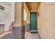Inviting front entrance featuring a green door and a stone pillar at 2865 Vigilante Ct, North Las Vegas, NV 89081