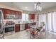 Modern kitchen with dark cabinets, stainless steel appliances, and a central island at 2865 Vigilante Ct, North Las Vegas, NV 89081