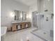 Elegant bathroom with a glass-enclosed shower, dual sinks, and neutral tones at 30 Dry Brook Trl, Henderson, NV 89052