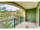 Green balcony with wrought-iron railing offers peaceful scenery and natural light, with seating for relaxation at 30 Strada Di Villaggio # 143, Henderson, NV 89011