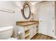 Classic bathroom featuring granite countertops, a vanity, and a large mirror at 30 Strada Di Villaggio # 143, Henderson, NV 89011
