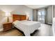 Cozy bedroom with hardwood floors, ample lighting, and a large window at 30 Strada Di Villaggio # 143, Henderson, NV 89011