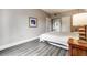 Comfortable bedroom with hardwood floors, an artful wall, and ample lighting at 30 Strada Di Villaggio # 143, Henderson, NV 89011