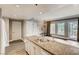 Open-concept kitchen with granite countertops, stainless sink, and hardwood floors at 30 Strada Di Villaggio # 143, Henderson, NV 89011
