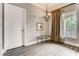 Well-lit living room with hardwood floors, large windows, and a chandelier at 30 Strada Di Villaggio # 143, Henderson, NV 89011