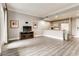 Comfortable living room with stylish decor, a modern entertainment center, and an open view of the kitchen at 30 Strada Di Villaggio # 143, Henderson, NV 89011