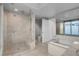 Modern bathroom featuring a glass shower and separate tub at 322 Karen Ave # 201, Las Vegas, NV 89109
