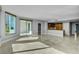 Bright living room with travertine floors, a modern kitchen, and large windows overlooking a city view at 322 Karen Ave # 201, Las Vegas, NV 89109