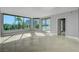 A bright living room with expansive windows and a sliding glass door with a city view at 322 Karen Ave # 201, Las Vegas, NV 89109