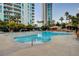 Resort-style community pool with lush landscaping, rock features, and sun loungers at 322 Karen Ave # 201, Las Vegas, NV 89109