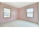 Bedroom featuring pink walls, carpeted floors, and windows allowing ample natural light at 343 W Basic Rd, Henderson, NV 89015