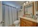 Cozy bathroom featuring a wood vanity, framed mirror, and shower with curtain at 3581 W Dyer Rd, Pahrump, NV 89048