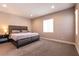 Serene bedroom with plush carpet, a large bed, and ample natural light from the window at 3830 Montone Ave, Las Vegas, NV 89141