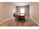 Formal dining room features tile flooring, a classic wood dining set, and a bright window at 3830 Montone Ave, Las Vegas, NV 89141