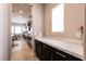 This butler's pantry has cabinets with stone countertops, leading to a kitchen with stainless steel appliances at 3830 Montone Ave, Las Vegas, NV 89141