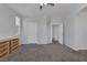 Spacious bedroom featuring an arched entryway, carpet floors and a ceiling fan at 3964 Irvin Ave, Las Vegas, NV 89141