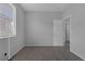 This bedroom features a gray color scheme, carpet flooring, and natural light from the window at 3964 Irvin Ave, Las Vegas, NV 89141