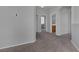 Hallway with carpet floors, neutral walls and multiple doorways at 3964 Irvin Ave, Las Vegas, NV 89141