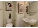 Clean bathroom with a pedestal sink, modern fixtures, and neutral decor, providing a comfortable space at 4068 Pistachio Nut Ave, Las Vegas, NV 89115