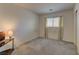 Simple bedroom with neutral walls, a window with blinds, and carpet flooring, providing a blank canvas at 4068 Pistachio Nut Ave, Las Vegas, NV 89115