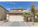 Charming two-story home with a tile roof, well-manicured lawn, and a two-car garage at 4068 Pistachio Nut Ave, Las Vegas, NV 89115