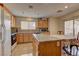 Well-equipped kitchen with an island, oak cabinets, and an adjacent dining area, creating a welcoming atmosphere at 4068 Pistachio Nut Ave, Las Vegas, NV 89115