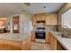 Functional kitchen featuring oak cabinets, a tile backsplash, and an open layout, perfect for everyday cooking at 4068 Pistachio Nut Ave, Las Vegas, NV 89115