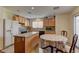 Bright kitchen with an island, oak cabinets, and stainless steel appliances, ideal for cooking and entertaining at 4068 Pistachio Nut Ave, Las Vegas, NV 89115