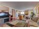 Bright living area flows into the kitchen featuring an island and modern appliances at 4068 Pistachio Nut Ave, Las Vegas, NV 89115