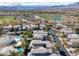 Expansive aerial view of a golf course community with beautiful homes and mountain views on a sunny day at 420 Pinnacle Heights Ln, Las Vegas, NV 89144
