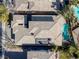 Overhead view of a beautiful home with a gray tile roof, sparkling pool and meticulously landscaped backyard at 420 Pinnacle Heights Ln, Las Vegas, NV 89144