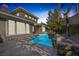 Beautiful backyard pool with an attached spa and lush landscaping, perfect for relaxation and entertaining at 420 Pinnacle Heights Ln, Las Vegas, NV 89144