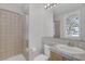 Bright bathroom offers a walk-in shower, tiled vanity, toilet, and shuttered window at 420 Pinnacle Heights Ln, Las Vegas, NV 89144