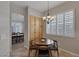 Cozy breakfast nook with a charming chandelier and natural light streaming through the shuttered window at 420 Pinnacle Heights Ln, Las Vegas, NV 89144