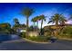 Stone gated community entrance with palm trees and manicured landscaping exudes exclusivity and curb appeal at 420 Pinnacle Heights Ln, Las Vegas, NV 89144