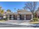 Inviting single-story home featuring a three-car garage, landscaped yard, and an attractive facade at 420 Pinnacle Heights Ln, Las Vegas, NV 89144