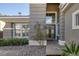 Elegant home entrance with stone accents, large windows, and well-maintained landscaping at 420 Pinnacle Heights Ln, Las Vegas, NV 89144