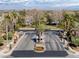Secure gated entry to the community features dual gates, lush landscaping, and a guard house at 420 Pinnacle Heights Ln, Las Vegas, NV 89144