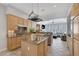 Spacious kitchen featuring light wood cabinets and granite countertops open to the living room at 420 Pinnacle Heights Ln, Las Vegas, NV 89144