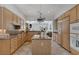 Spacious kitchen featuring light wood cabinets and granite countertops open to the living room at 420 Pinnacle Heights Ln, Las Vegas, NV 89144