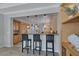 Eat-in kitchen featuring light wood cabinets, granite countertops and a breakfast bar at 420 Pinnacle Heights Ln, Las Vegas, NV 89144