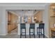 Eat-in kitchen featuring light wood cabinets, granite countertops and a breakfast bar at 420 Pinnacle Heights Ln, Las Vegas, NV 89144
