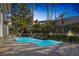 Backyard pool with waterfall feature, lush landscaping, outdoor seating and palm trees at 420 Pinnacle Heights Ln, Las Vegas, NV 89144