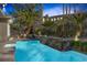 Backyard pool with waterfall feature, lush landscaping, outdoor seating and palm trees at 420 Pinnacle Heights Ln, Las Vegas, NV 89144