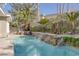 Inviting backyard pool with decorative waterfall feature and lounge area with comfortable seating at 420 Pinnacle Heights Ln, Las Vegas, NV 89144