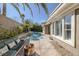 Backyard with pool, patio with a fire pit, and lush tropical landscaping for privacy at 420 Pinnacle Heights Ln, Las Vegas, NV 89144